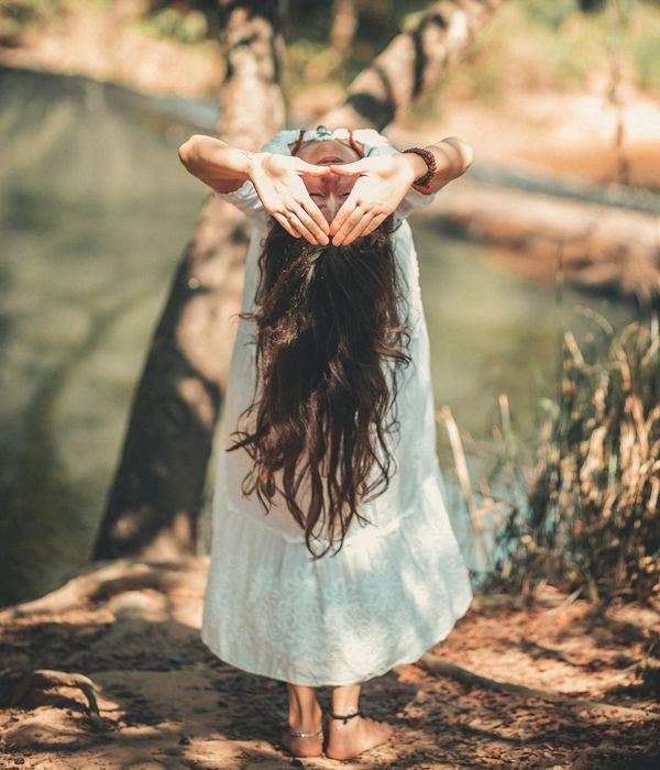 Woman performing a serene yoga pose in a calm environment.